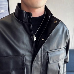Detail of men's black faux leather jacket with stand collar and double chest pockets