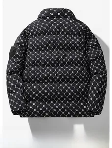 Detail view of the B monogram pattern and sleeve badge on a quilted black puffer jacket