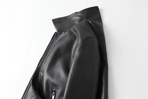 Detail of premium black PU leather jacket showing fine texture and silver metal zipper