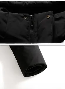 Detail of metal zipper closure and elastic windproof cuffs on black winter parka jacket