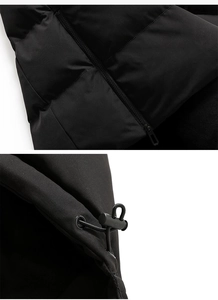 Detail of black quilted fabric with smooth resin zipper and adjustable toggle drawstrings