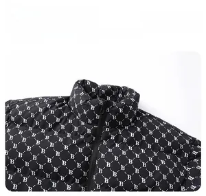 Detailed close-up of high collar quilted puffer jacket featuring white B-letter patterns