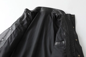 Detail of black PU leather jacket featuring stand collar and metal zipper with snap buttons