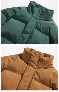 Detail of stand collar puff jacket in dark green and caramel brown with matte finish