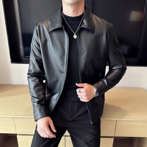 Detail shot of black faux leather texture with sleek lapel and smooth metal zipper