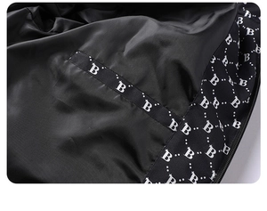 Detail view of the sleek satin lining and internal pocket with B-pattern on a winter jacket