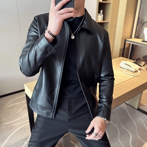 Close-up of black PU leather blazer with notch lapel and metallic zipper pockets
