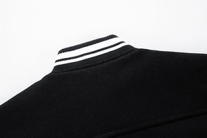Detail shot of black and white striped ribbed collar on wool baseball jacket