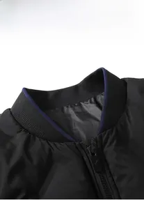 Detail of black stand collar jacket with ribbed texture and blue inner trim