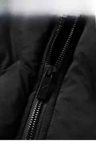 Macro shot of high-quality copper zipper detail on black winter jacket for men