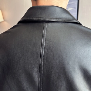 Detail of black PU leather jacket showing back collar and premium stitching texture