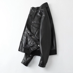 Detail of a black faux leather biker jacket with stand collar and ribbed cuffs