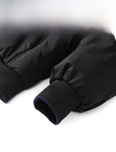 Close-up of black windproof jacket cuff with elastic ribbed design and blue lining trim