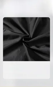 Detail of smooth black inner lining fabric for men's motorcycle jacket, silky texture