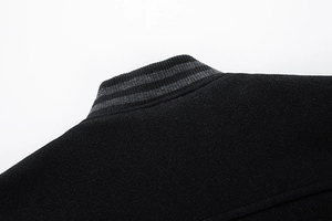 Close-up of a striped ribbed baseball collar on a black quilted wool jacket