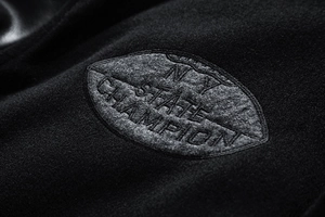 Detailed view of NY STATE CHAMPION felt embroidery on a warm wool baseball jacket
