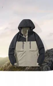 Detail of waterproof outdoor jacket with hood showing two-tone black and beige panels