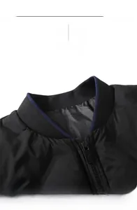 Detail of ribbed knit collar on black bomber jacket with blue stripe and metal zipper