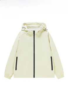 Detail of beige windproof hooded jacket with black zippers and elastic cuffs