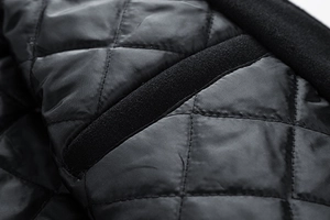 Close-up of diamond-quilted jacket lining with black fleece trim and detailed stitching