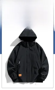 Detailed view of black windproof jacket featuring elastic cuffs and yellow G.O.D leather tag