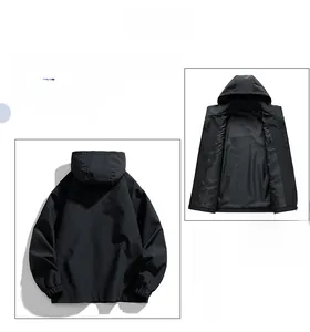 Detail view showing black hooded men's jacket with windproof fabric and reversible design