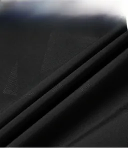 Detailed close-up of high-density black synthetic fabric with geometric triangle patterns