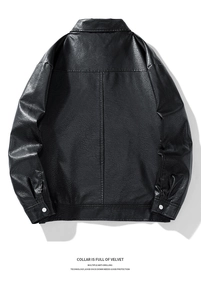 Detail view of the black leather jacket back featuring vertical stitching and silver buttons