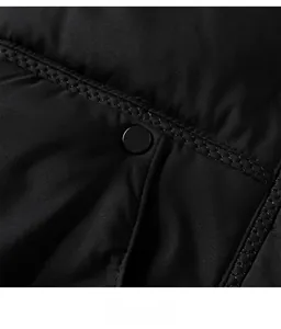 Close-up of black padded jacket featuring metal snap buttons and diamond quilting detail