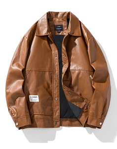 Macro shot of brown leather jacket featuring stand collar and CLEANER patch detail