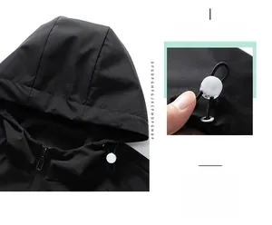 Detail view of black waterproof jacket showing adjustable hood and white toggle drawstring