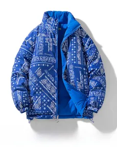 Detail of blue and white paisley print with metal zipper puller on quilted puffer jacket