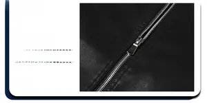 Detail shot of a smooth metal zipper and textured black PU leather jacket fabric