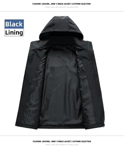 Detail view of the smooth windproof lining of a black men's hooded outdoor jacket