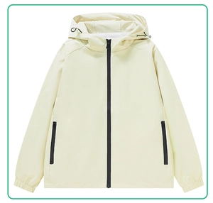 Close-up of a beige hooded jacket with black zippers and adjustable drawstring details