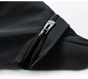 Detail of high-quality metal zipper and textured windproof fabric on black jacket