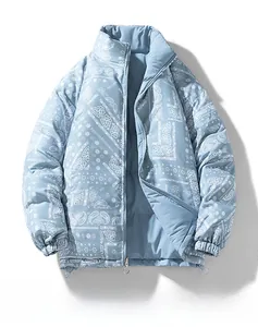 Detail of light blue paisley puffer jacket featuring stand collar and metal zipper