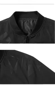 Detail of the ribbed collar and metallic zipper on a black bomber jacket with geometric prints
