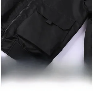 Detail of MA1 flight jacket featuring a cargo pocket and elastic ribbed hem in black