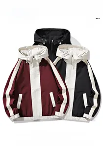 Detail of color-block hooded windbreakers with white side stripes and zipper closure
