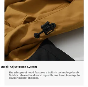Detail of the quick-adjust hood toggle on a yellow and black waterproof outdoor jacket