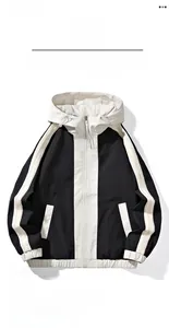 Detail of color-block casual jacket with striped sleeve ribbon and adjustable hood drawstring