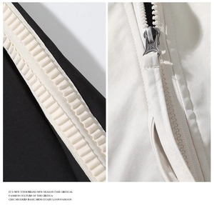 Detailed macro view of black and white contrast zipper with JSK puller on windbreaker