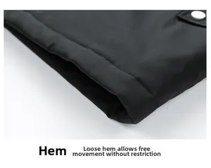 Detail of loose black outdoor jacket hem with precise stitching and metallic snap button