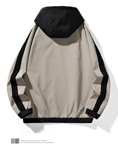 Back view of a khaki and black windbreaker jacket with ribbed cuffs and sporty stripes