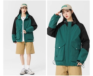 Detail of green and black outdoor utility jacket with large pockets and hooded design