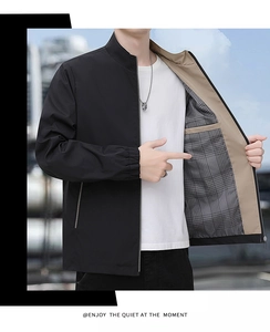 Detail of men's business jacket showing inner pocket and classic plaid lining texture