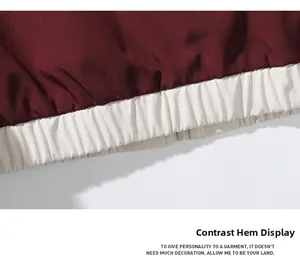 Detailed macro view of burgundy and cream contrast ribbed elastic hem on casual jacket