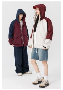 Close-up of matching outdoor mountain jackets with color-block design and cargo pockets
