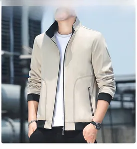 Detail of men's slim fit beige jacket showing ribbed collar and metallic zipper texture